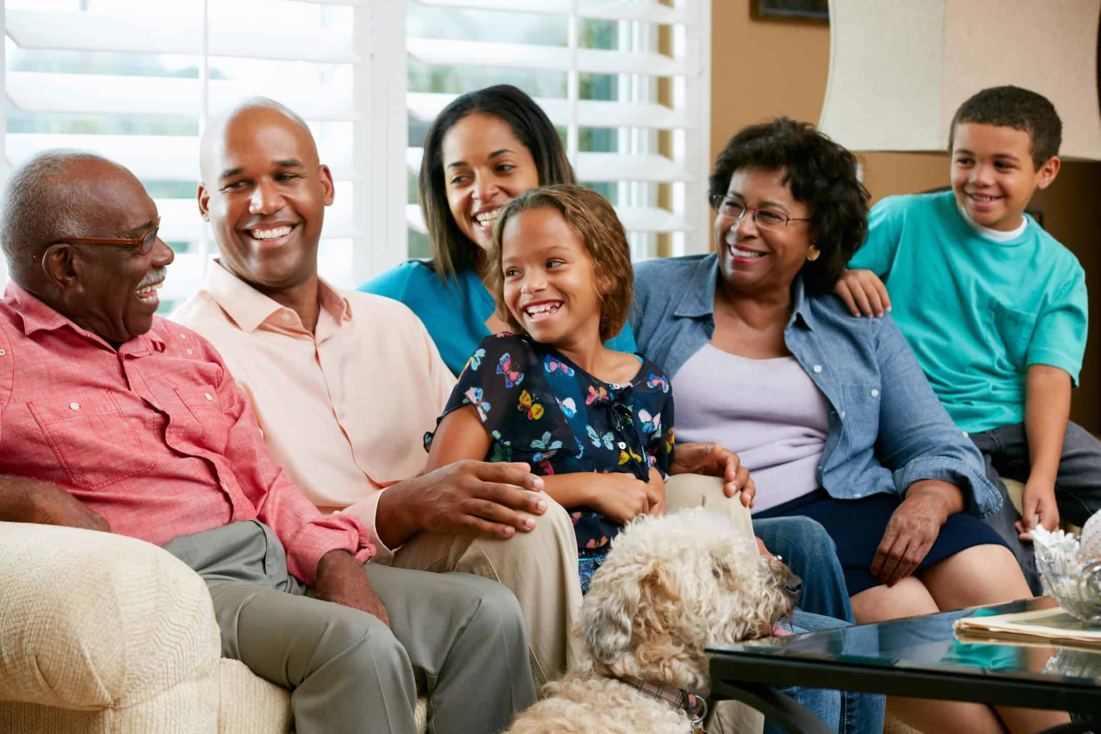 Happy family sitting and talking together on sofa.