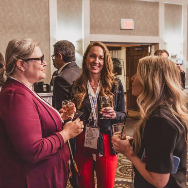 People networking at a social event with drinks.