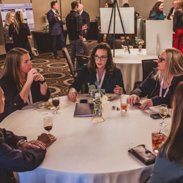 People discussing around a conference table.