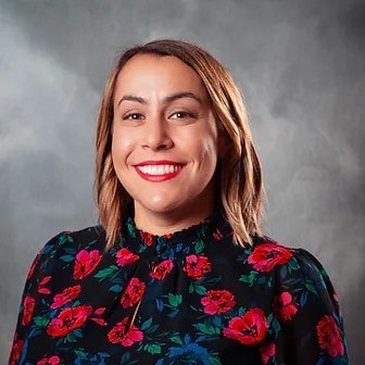 Smiling person in floral blouse portrait
