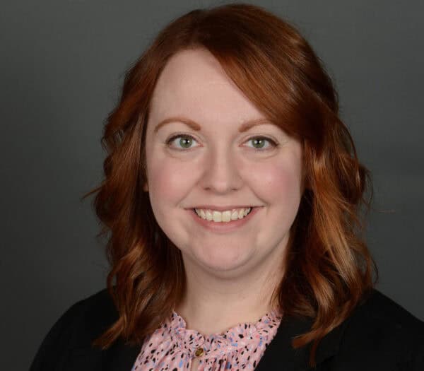 Smiling red-haired woman in a professional portrait